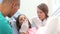 Little girl and dental assistant doing high-five after teeth checkup