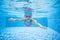 Little girl diving in swimming pool
