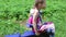 Little girl does abs exercises on outdoor exerciser in green park