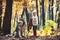 Little girl with dog in autumn forest. Red riding hood with wolf in fairy tale woods. Child play with husky and teddy