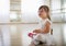 Little girl with down syndrome at ballet class in dance studio,sitting and resting. Concept of integration and education