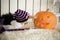 Little girl with Down Syndrome finger touches the eyes of a pumpkin on Halloween