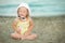 Little girl with Down syndrome playing sunglasses on the beach