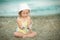 Little girl with Down syndrome playing sunglasses on the beach