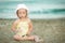 Little girl with Down syndrome playing sunglasses on the beach