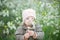 Little girl with Down syndrome smelling flowers