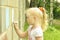Little girl drawing with chalk on the wall
