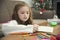 Little girl drawing a colorful pictures using pencil crayons