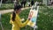Little girl draws color picture on easel in green park on summer festival.