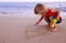 Little girl draws a house by the sea