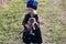 Little girl in a dress and a beret with a gray kitten in hand