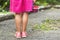 Little girl in dress child hand holdind small basket of ripe raspberries. Close-up