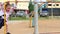 Little girl in dress plays on children playground at summer day