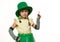 Little girl dressed as Leprechaun for St. Patrick's Day party, points her finger at copy ad space on white