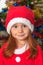 Little girl dressed as Santa Claus