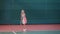 Little girl dressed in sport outfit is having training at indoor tennis court. Young female sportswoman is playing