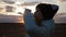 Little girl drinking fresh water from plastic bottle with sunset background. To quench your thirst.