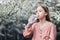 A little girl drinks clean fresh water from a plastic bottle