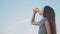 Little girl drinks with plastic bottles slow motion video. girl teenager drinks juice and water exercise lifestyle sport