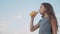 Little girl drinks with plastic bottles slow motion video. girl teenager drinks juice and water exercise sport lifestyle