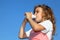 Little girl drinks yoghurt from small bottle