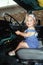 Little girl in driver\'s seat of big rig truck