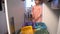 Little Girl Drops The Trash Into Kitchen Recycling Bin.