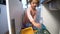 Little Girl Drops The Trash Into Kitchen Recycling Bin. Slow motion.