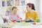 Little girl dyeing eggs for Easter with her mother