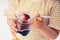 Little girl eat milky dessert with cream and fruity jelly in a jar