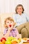 Little girl eat strawberry fruit with grandmother