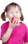 Little girl eating apple