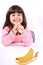 Little girl eating banana