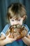 little girl eating a big circle rye bread