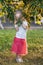 Little girl eating bird cherry from tree