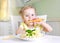 Little girl eating carrot,vegetables,healthy food.Child`s nutrition