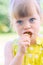 Little girl eating delicious freshly picked red strawberries - berries collected in the home garden