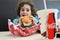 Little girl eating fast food