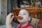 Little girl eating fried eggplant slice in restaurant