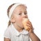 Little girl eating icecream on white