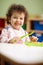 Little girl eating lunch in kindergarten