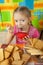 Little girl eating milk dessert