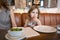 Little girl eating olive in restaurant