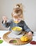 Little Girl Eating Pumpkin Cream-Soup at Home