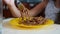 The little girl eats buckwheat noodles with a fork reluctantly. The child refuses to eat. Slow-motion shooting.