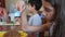 The little girl eats buckwheat noodles with a fork reluctantly. The child refuses to eat. Slow-motion shooting.