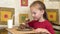 Little girl eats cake using a spoon. A happy child loves sweetness.