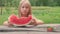 Little girl eats watermelon. Portrait of child eats watermelon slices.
