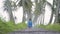 little girl in empty road with coconut tree
