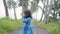 little girl in empty road with coconut tree